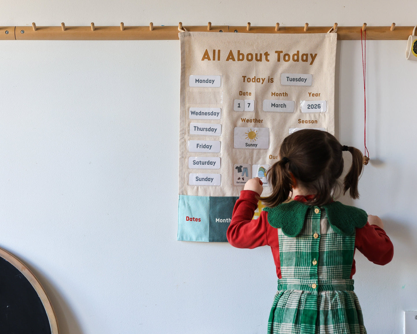 Child looking at a 'All About Today' chart on a wall